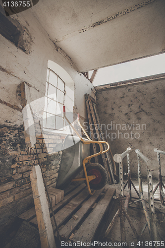 Image of Wheelbarrow in a warn barn