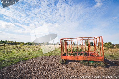 Image of Rural landscape with a cage on a field