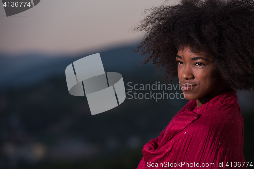 Image of outdoor portrait of a black woman with a scarf