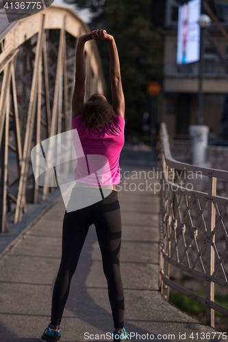 Image of Black woman doing warming up and stretching