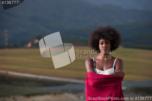 Image of outdoor portrait of a black woman with a scarf