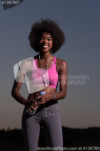 Image of african american woman jogging in nature