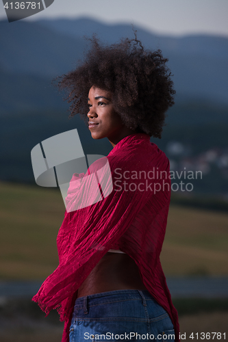 Image of outdoor portrait of a black woman with a scarf