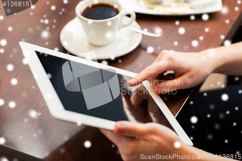 Image of woman with tablet pc and coffee