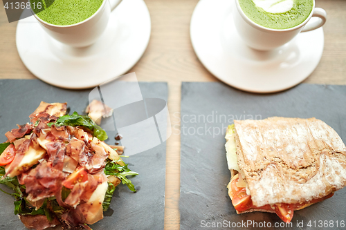 Image of salad, sandwich and matcha green tea at restaurant