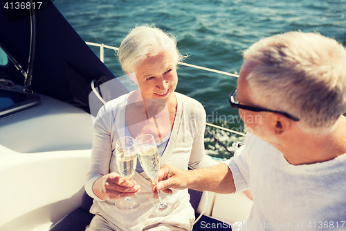 Image of senior couple clinking glasses on boat or yacht