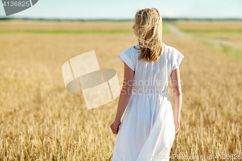 Image of young woman in white dress on cereal field