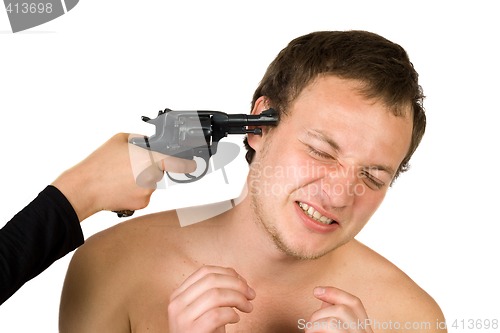 Image of The young man with a pistol at a head. isolated