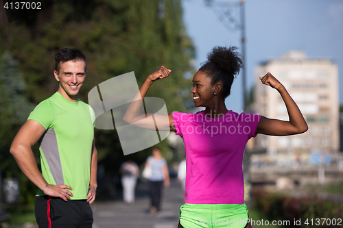 Image of portrait of young multietnic jogging couple ready to run