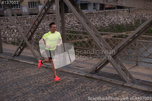 Image of a young man jogging in the city