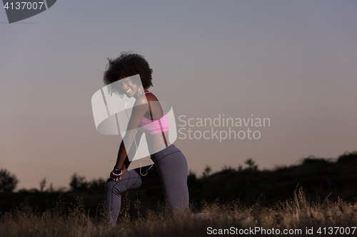 Image of black woman is doing stretching exercise relaxing and warm up