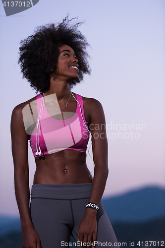 Image of portrait of african american woman jogging in nature