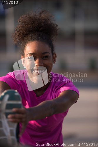 Image of African American woman doing warming up and stretching