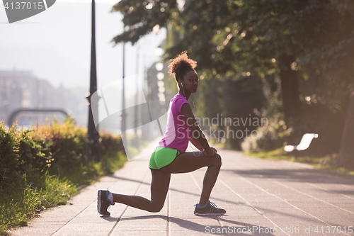 Image of Black woman doing warming up and stretching