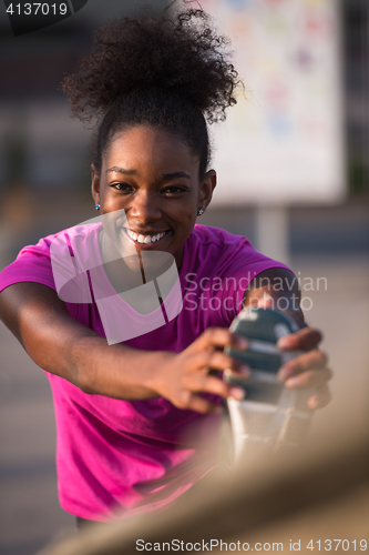 Image of African American woman doing warming up and stretching