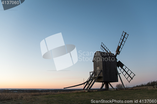 Image of Old wooden windmill by evening light