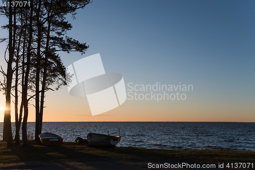 Image of Sunset with rowing boats by the coast