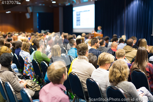 Image of Audience in lecture hall participating at business event.