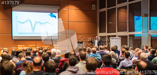 Image of Business speaker giving a talk in conference hall.