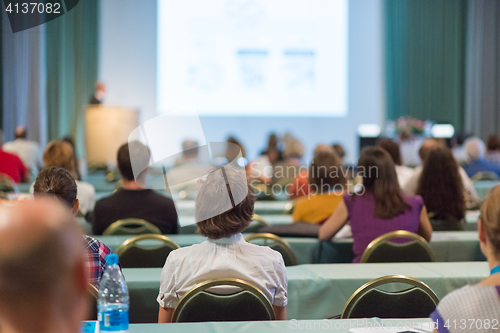 Image of Audience in lecture hall participating at business conference.