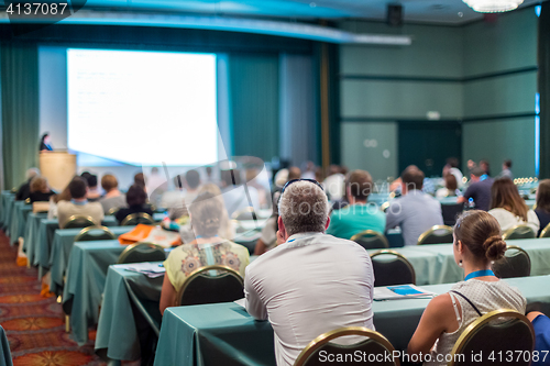 Image of Audience in lecture hall participating at business conference.