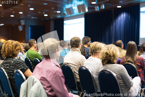 Image of Audience in lecture hall participating at business event.