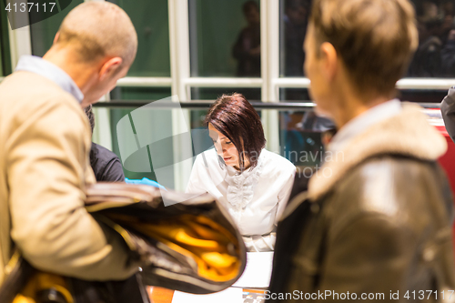 Image of Personal assistant working at registration desk at corporate event.