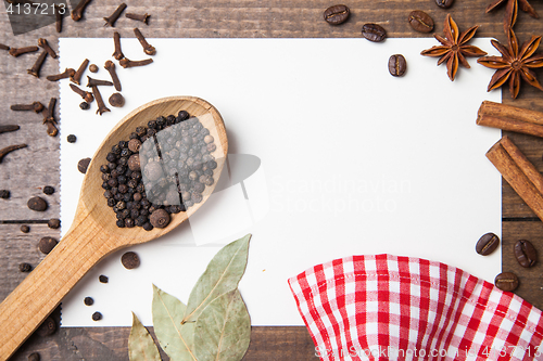 Image of paper for recipes and spices on wooden table