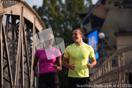 Image of multiethnic couple jogging in the city
