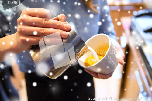 Image of close up of woman making coffee at shop or cafe