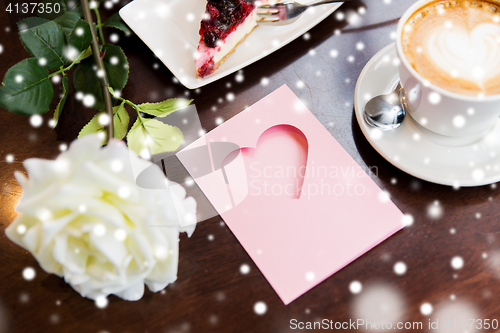 Image of close up of greeting card with heart and coffee