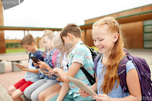 Image of group of happy elementary school students talking