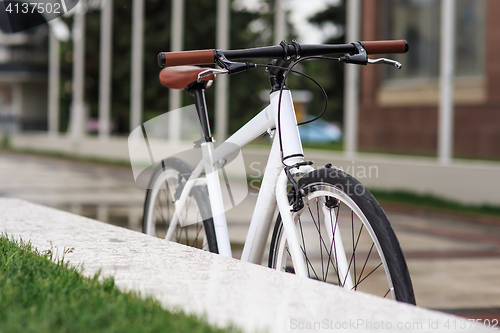 Image of white fixed-gear bicycle on street