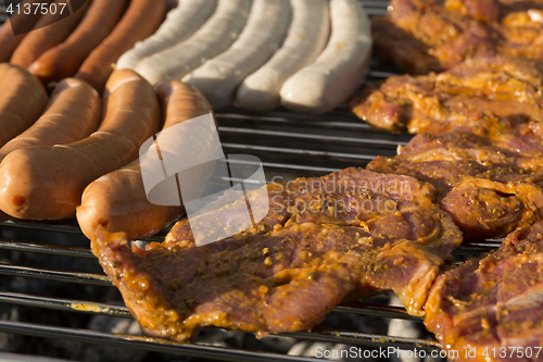 Image of Meat and sausages on a barbecue grill