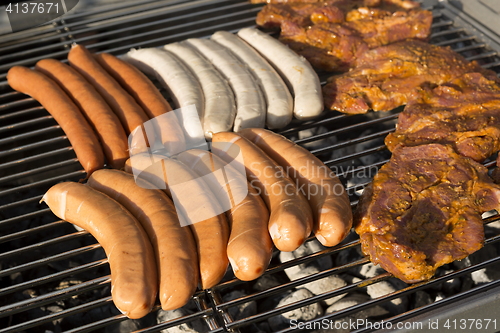 Image of Meat and sausages on a barbecue grill