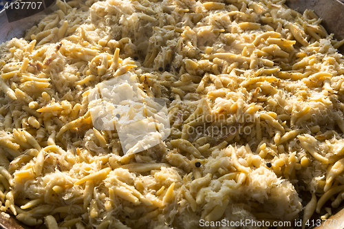 Image of Golden potato dumplings with sauerkraut in a big pan