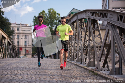 Image of multiethnic couple jogging in the city