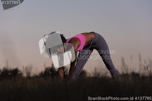 Image of black woman is doing stretching exercise relaxing and warm up