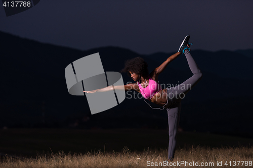 Image of black woman doing yoga  in the nature