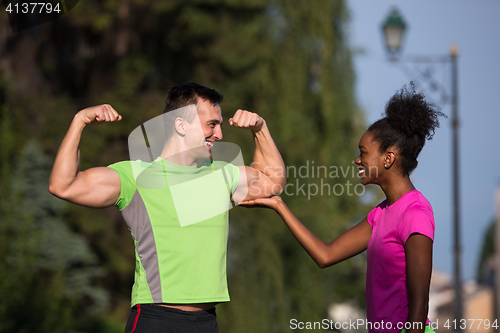 Image of portrait of young multietnic jogging couple ready to run