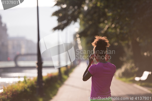 Image of portrait of young african american jogging woman