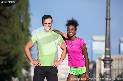 Image of portrait of young multietnic jogging couple ready to run
