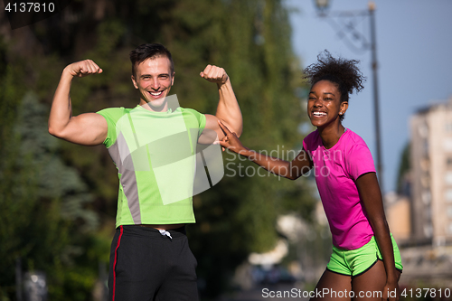 Image of portrait of young multietnic jogging couple ready to run