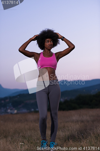 Image of portrait of african american woman jogging in nature