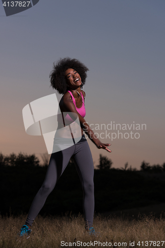 Image of black woman is doing stretching exercise relaxing and warm up