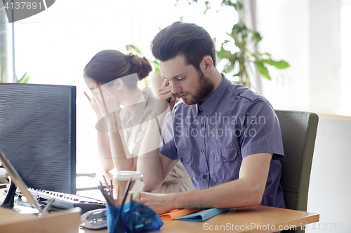 Image of business team with computer and files in office