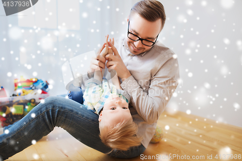 Image of father with son playing and having fun at home