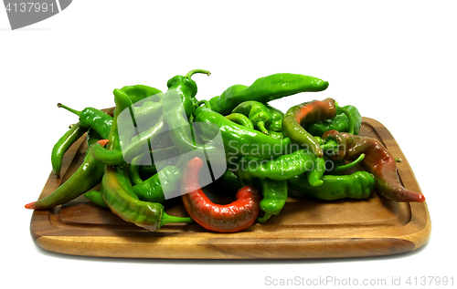 Image of Multicolor hot peppers on wooden kitchen board