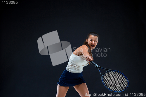 Image of Portrait of beautiful girl tennis player with a racket on dark background