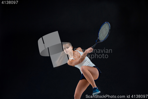 Image of Portrait of beautiful girl tennis player with a racket on dark background